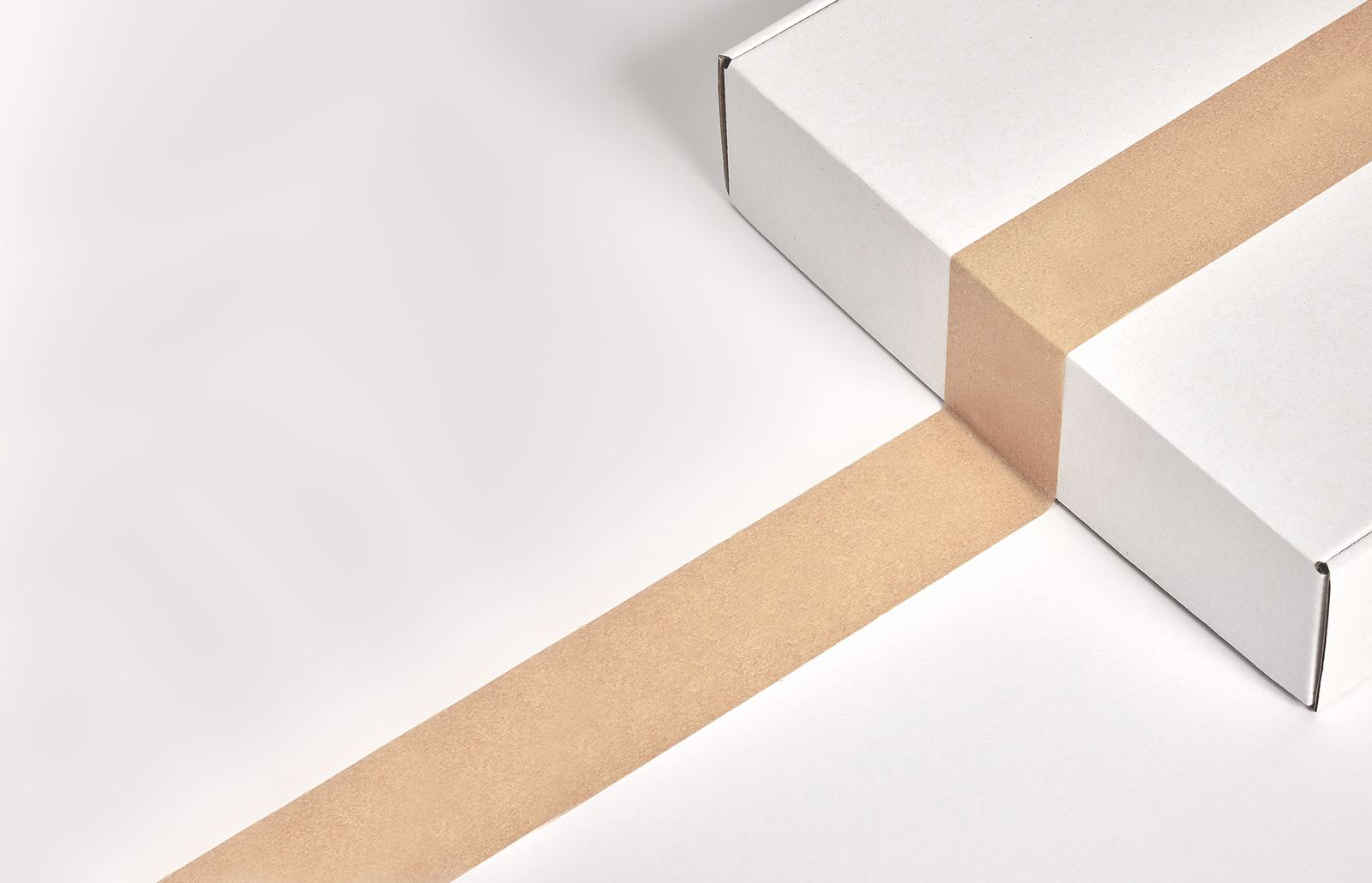 A white corrugated box sealed with kraft tape