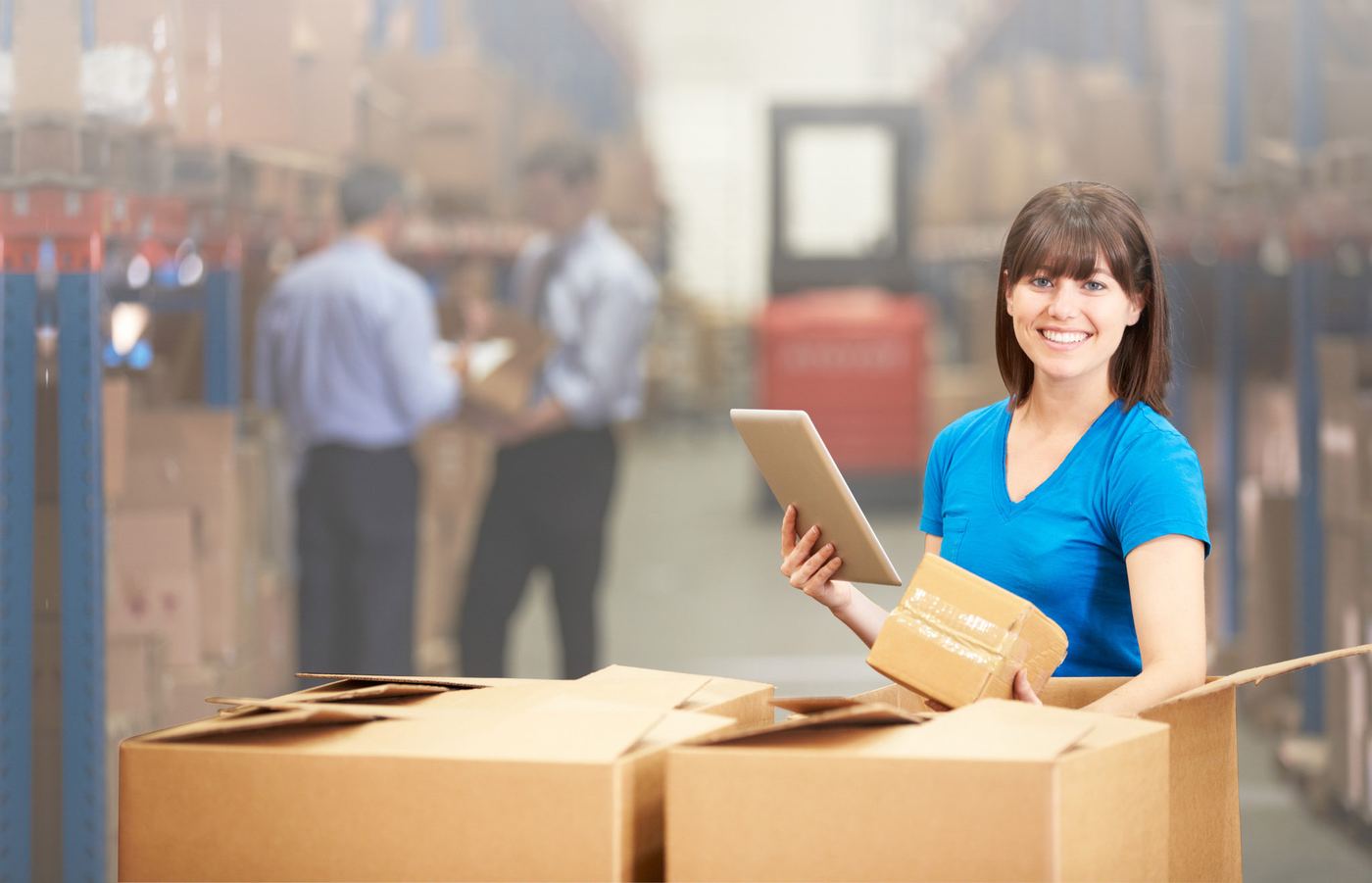 A packer at a station with open corrugated boxes