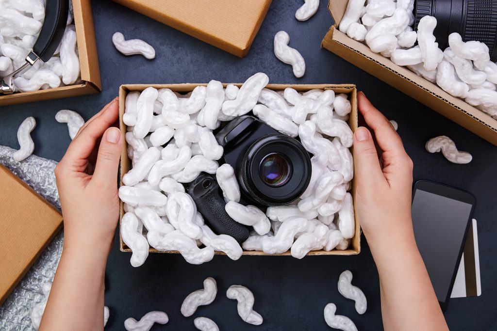 A camera packed securely in a corrugated box