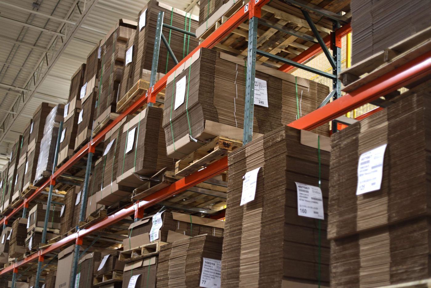 Racks of stocked corrugated boxes in a warehouse