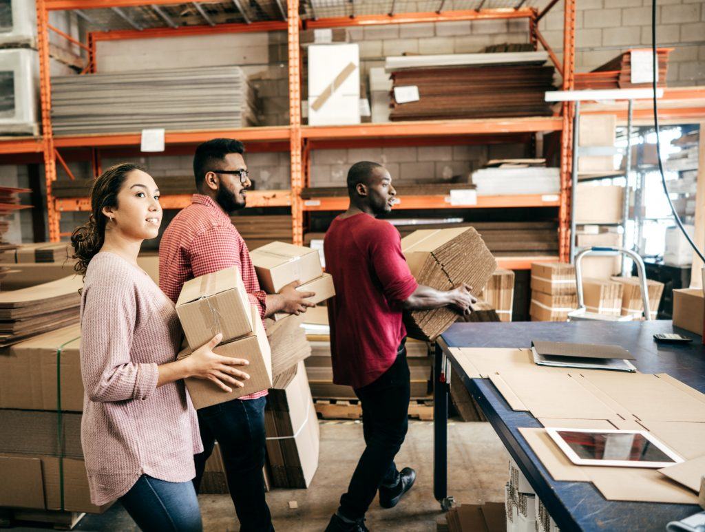 A team packing boxes in a warehouse